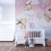 Muurschildering met konijntjes op wolken tussen roze ballonnen Kleine konijntjes op wolken voor kinderkamer - belangrijkste product afbeelding
