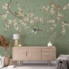 Fotobehang in elegante groentinten met Aziatisch motief Vogels in kersenbloesems - belangrijkste product afbeelding